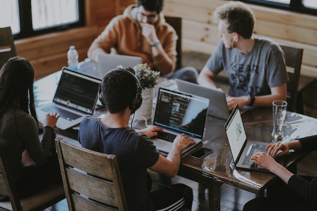 Cross platform mobile app development team collaborating on a hybrid app