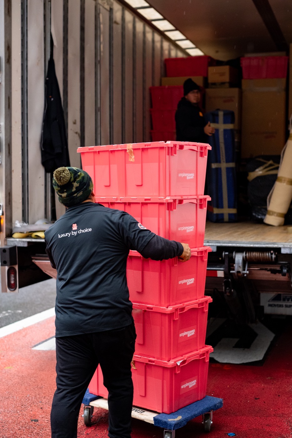Professional packers and movers crew loading crates onto a moving truck